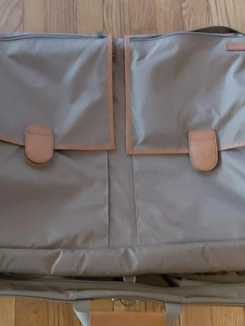 Features 2 deep front pockets with exterior/ interior zipper compartments galore